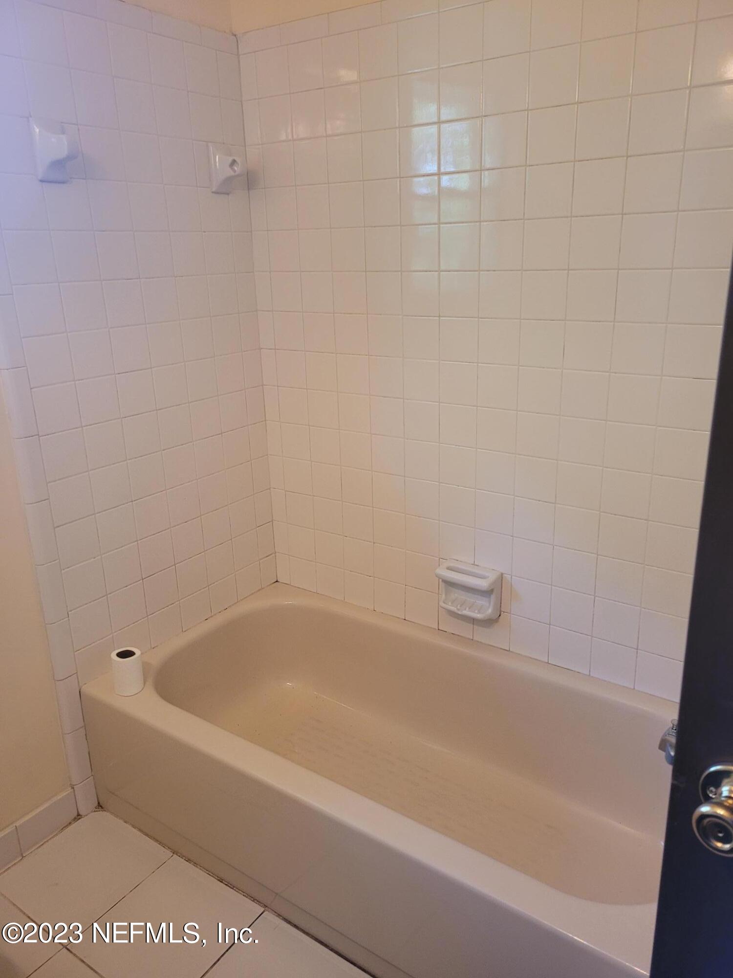 7925 Chateau Drive Jacksonville, FL 32221 - Photo 15 of 24 a white bath tub and a shower