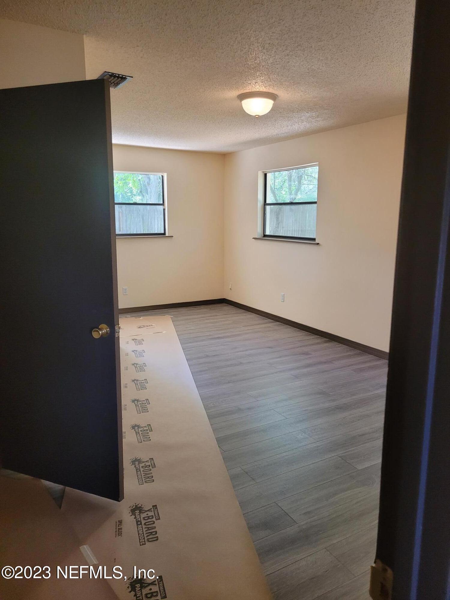 7925 Chateau Drive Jacksonville, FL 32221 - Photo 17 of 24 a view of a hallway with wooden floor