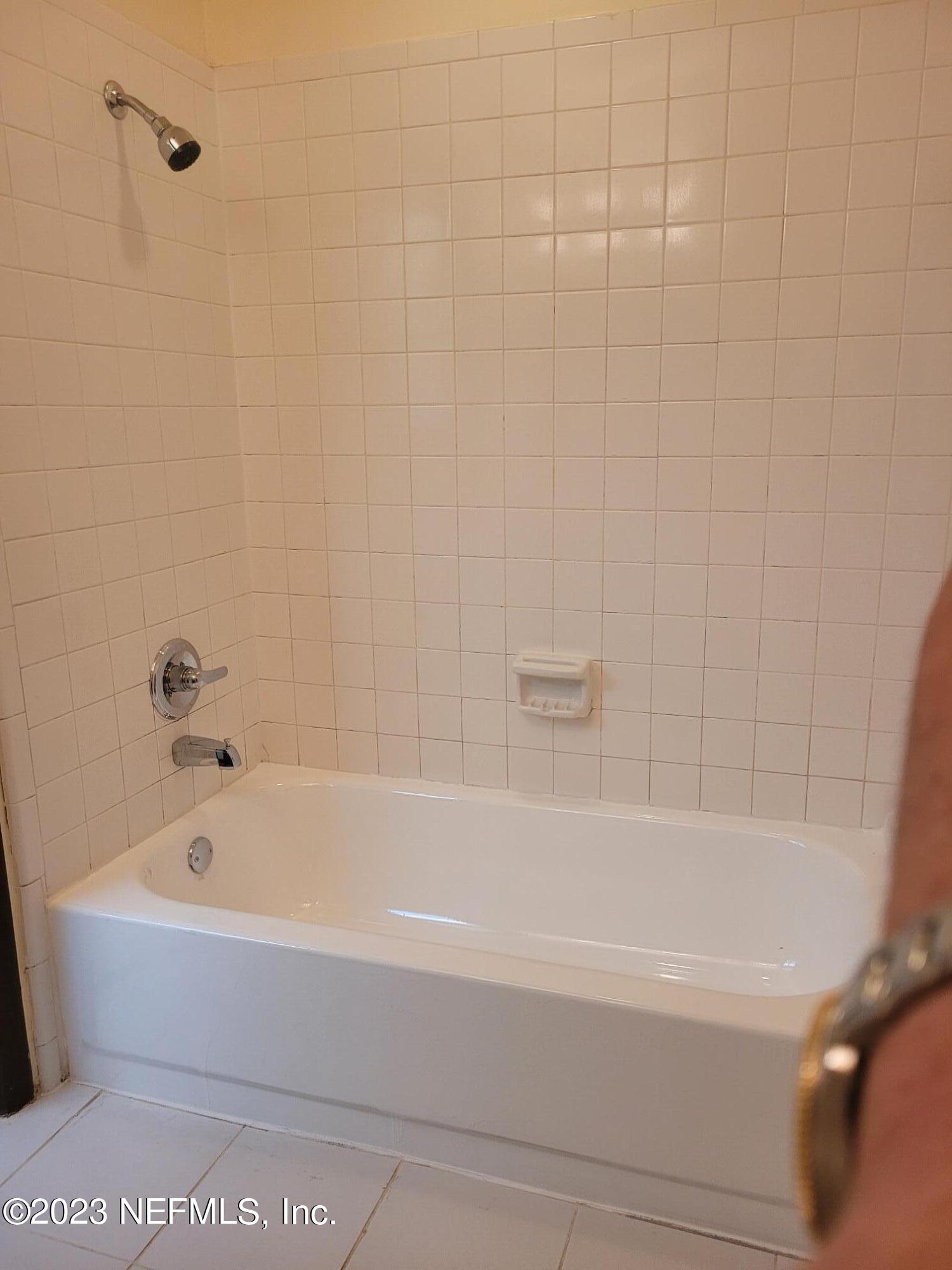 7925 Chateau Drive Jacksonville, FL 32221 - Photo 18 of 24 a white bath tub and a shower