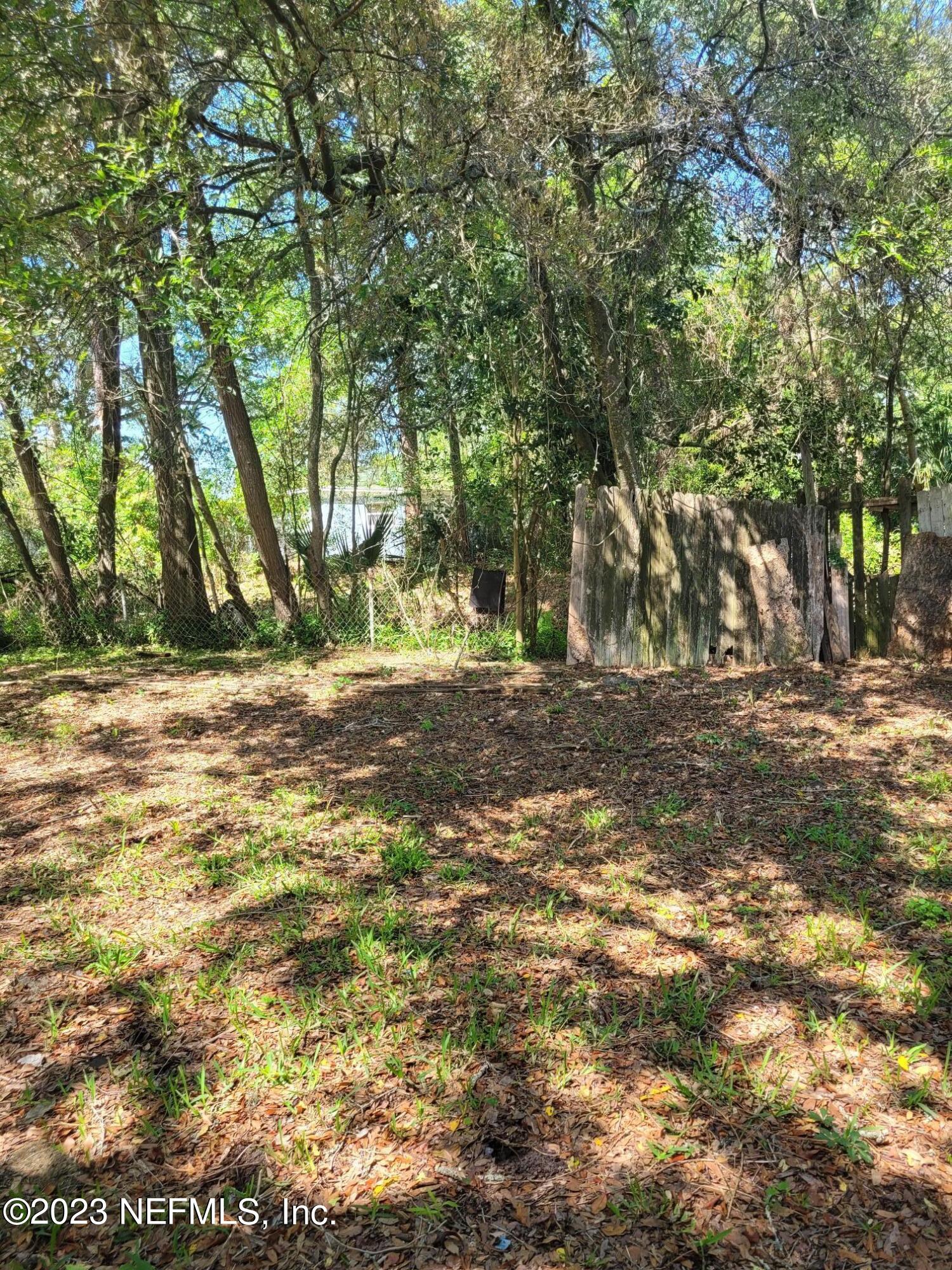 7925 Chateau Drive Jacksonville, FL 32221 - Photo 20 of 24 a view of dirt field with trees