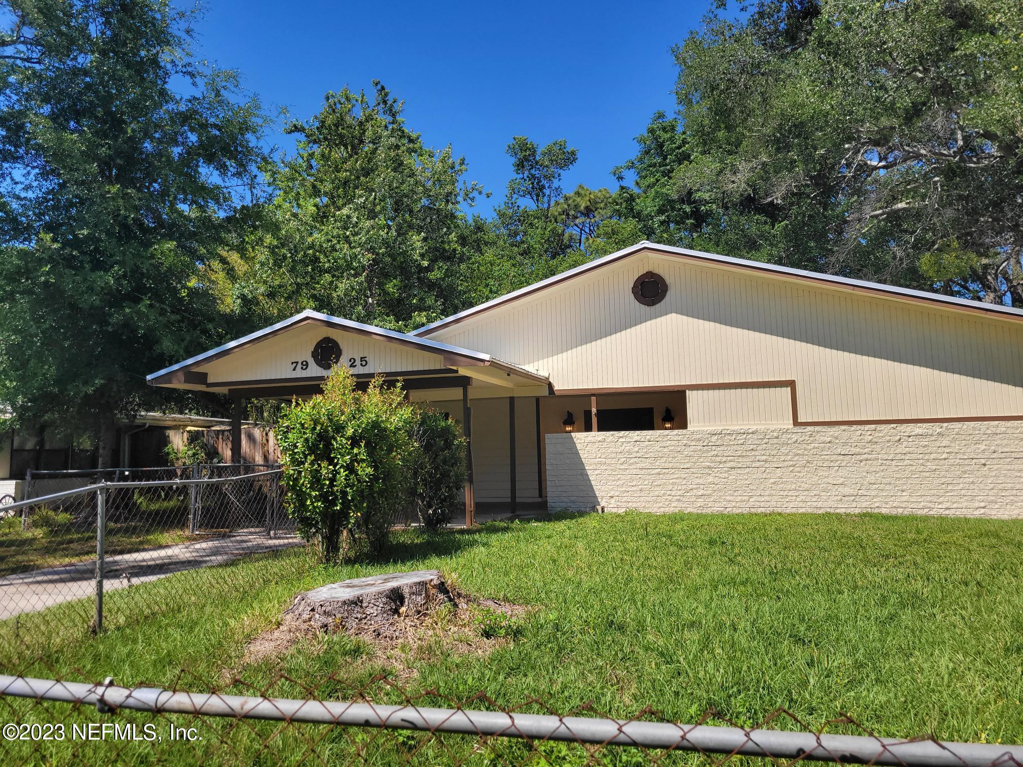 7925 Chateau Drive Jacksonville, FL 32221 - Photo 3 of 24 a front view of a house with garden