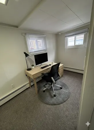 a workspace with furniture and a window