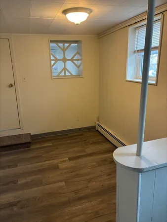a view of room with window and wooden floor