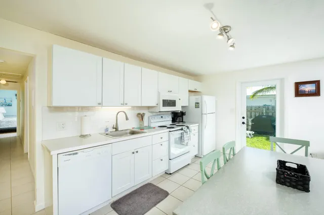 a view of yard from deck with patio