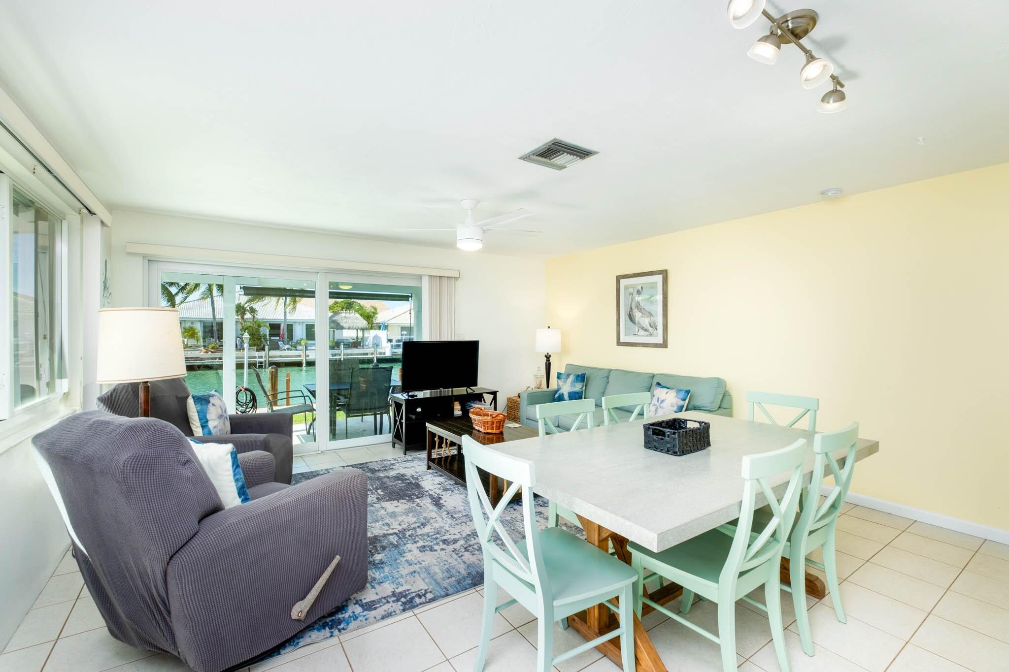 261-271 9th Street Key Colony Beach, FL 33051 - Photo 16 of 68 a dining room with furniture a large window and a projector