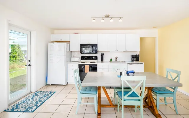 a view of ocean with boats and trees in the background
