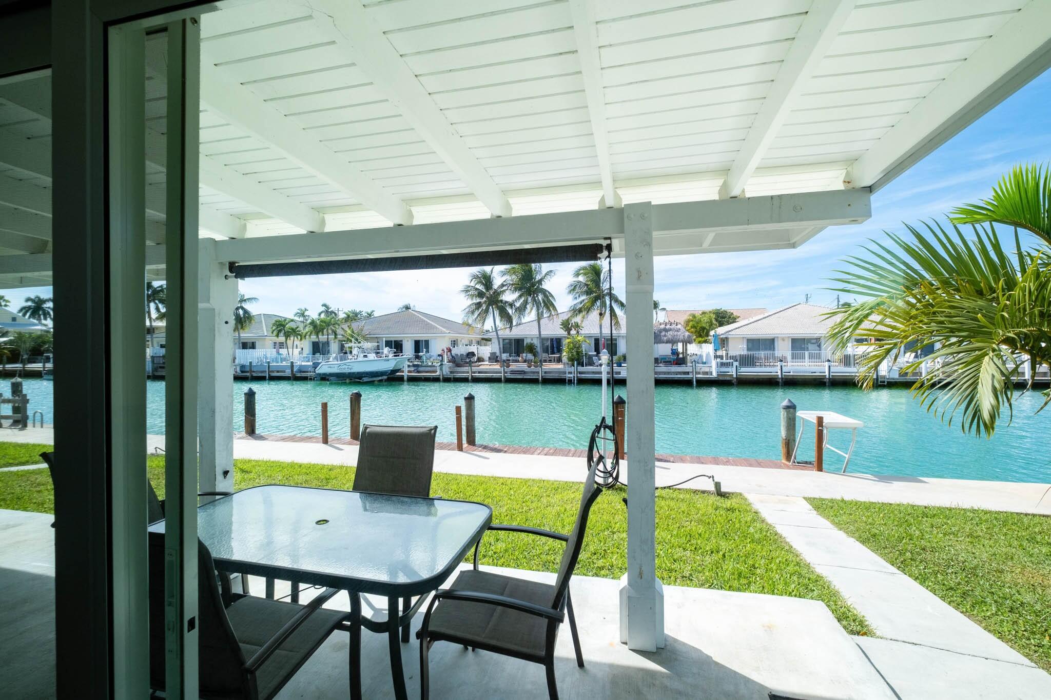 261-271 9th Street Key Colony Beach, FL 33051 - Photo 41 of 68 a view of swimming pool with a table and chairs