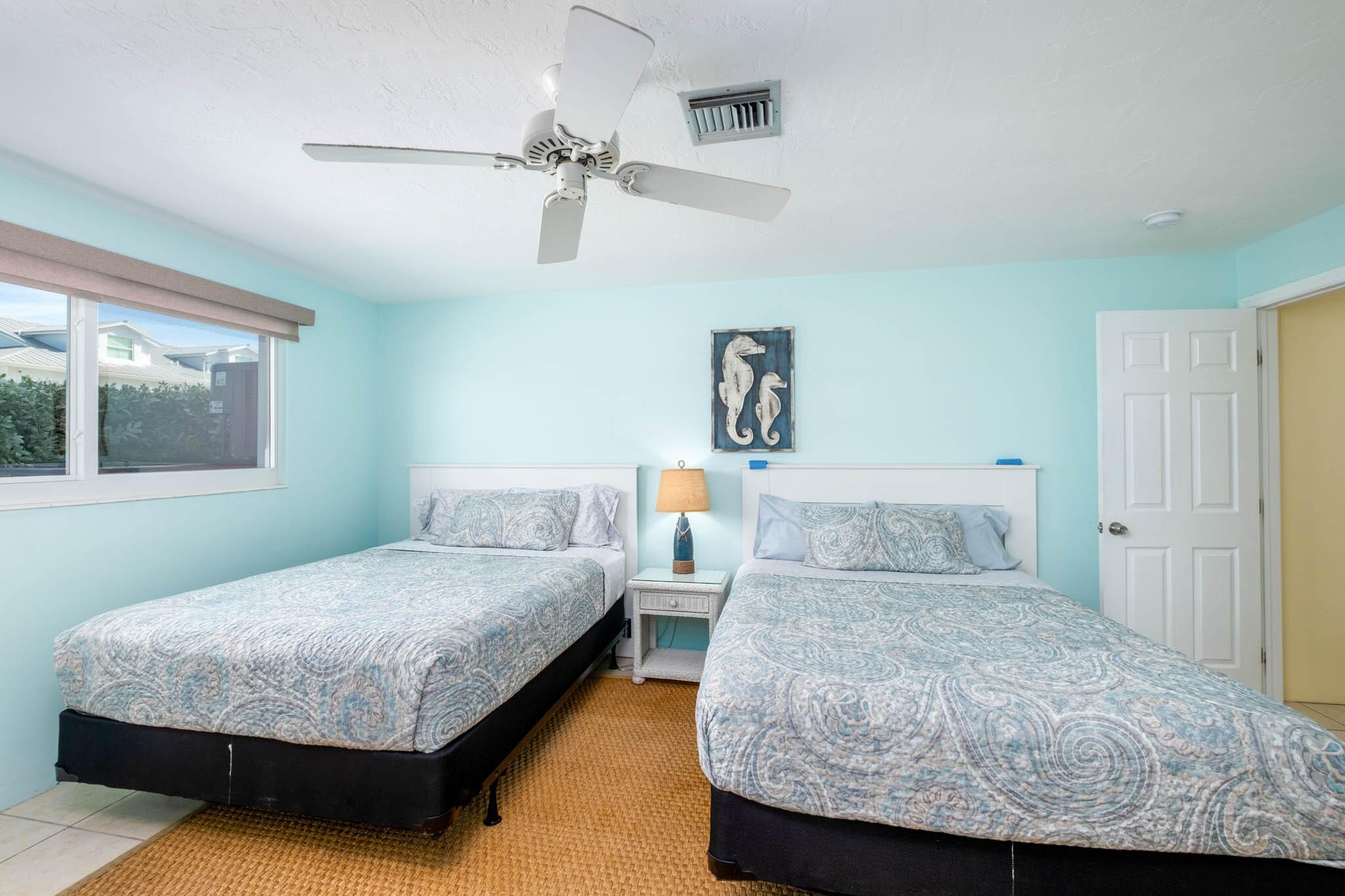 261-271 9th Street Key Colony Beach, FL 33051 - Photo 43 of 68 a bedroom with a bed and window