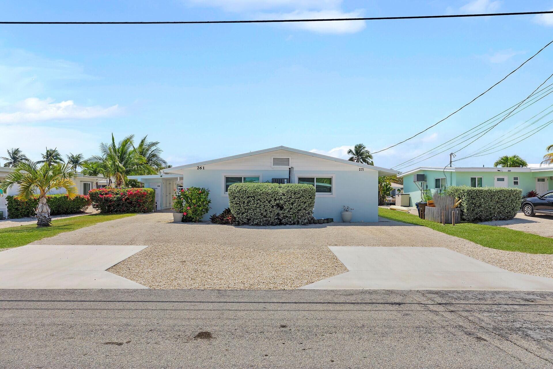 261-271 9th Street Key Colony Beach, FL 33051 - Photo 7 of 68 a front view of a house with a yard and garage