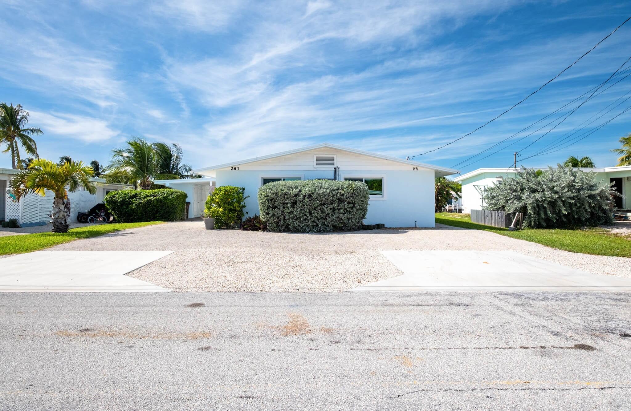 261-271 9th Street Key Colony Beach, FL 33051 - Photo 8 of 68 a front view of a house with a yard and garage