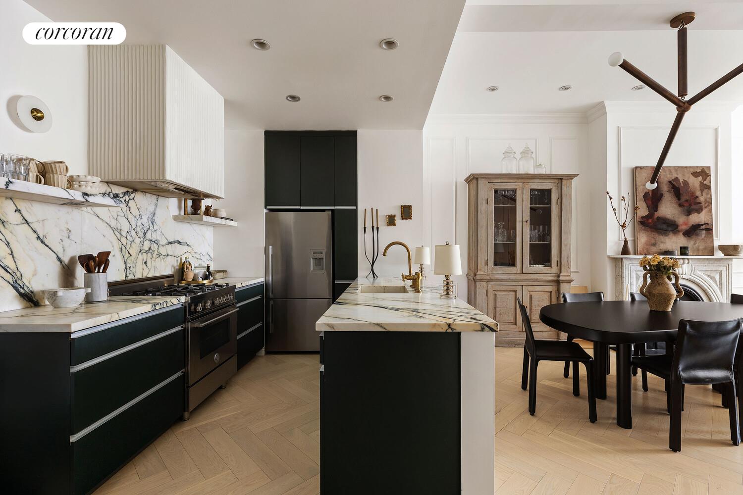 315 7th Avenue, Unit 4D Manhattan, NY 10001 - Photo 11 of 19 a kitchen with stainless steel appliances granite countertop a sink stove and refrigerator