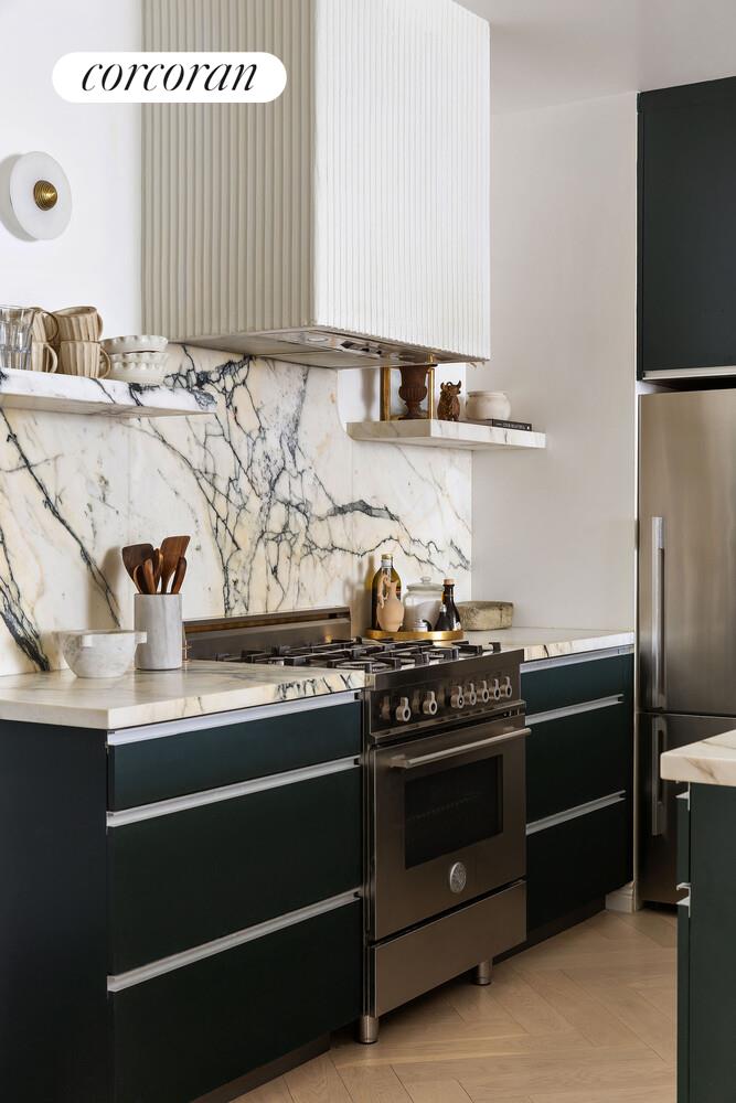 315 7th Avenue, Unit 4D Manhattan, NY 10001 - Photo 12 of 19 a kitchen with a stove and a refrigerator