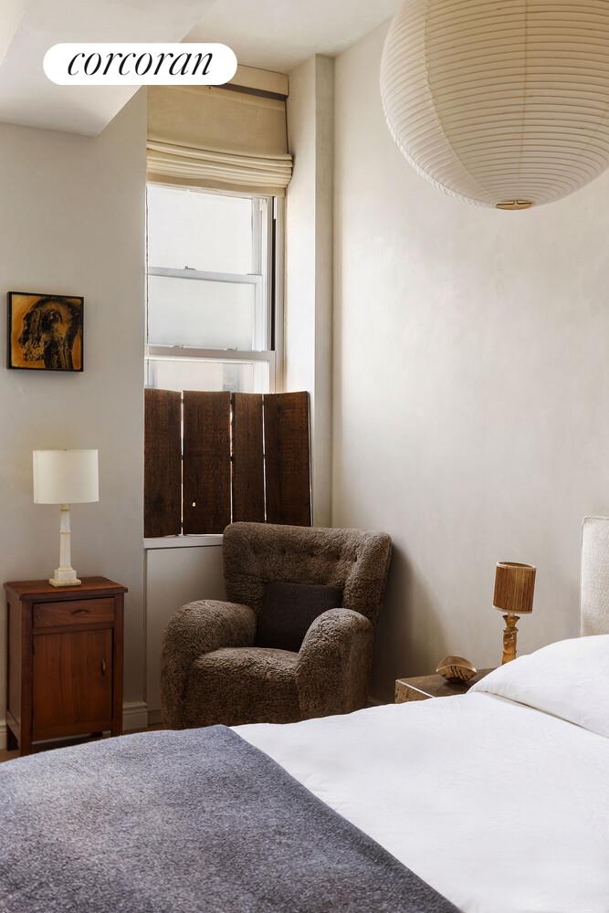 315 7th Avenue, Unit 4D Manhattan, NY 10001 - Photo 16 of 19 a bedroom with a bed and a couch