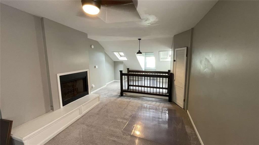 615 Tripoli Street Pittsburgh, PA 15212 - Photo 15 of 25 wooden floor in an empty room with a fireplace and a window