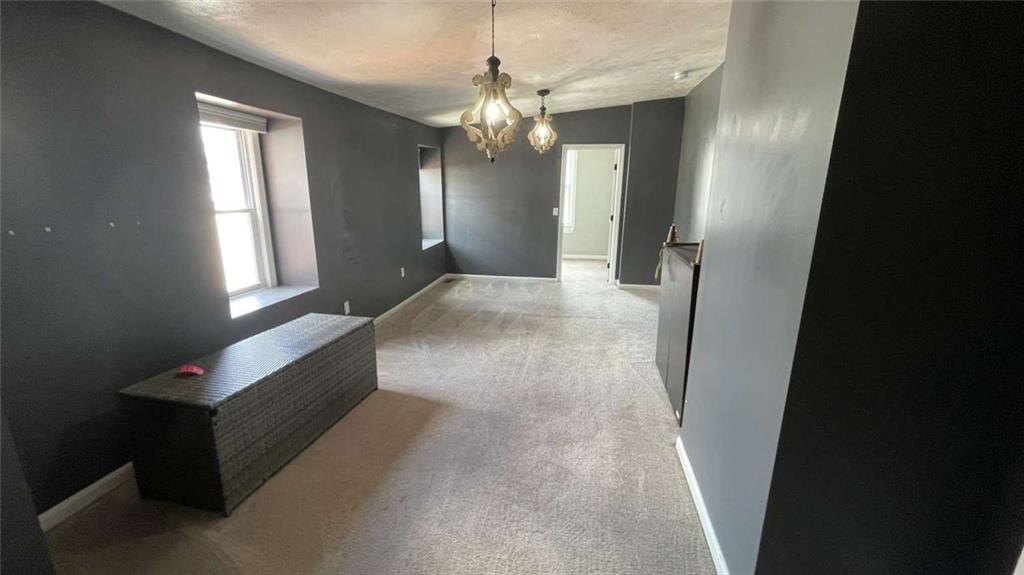 615 Tripoli Street Pittsburgh, PA 15212 - Photo 16 of 25 a view of a hallway with windows and chandelier