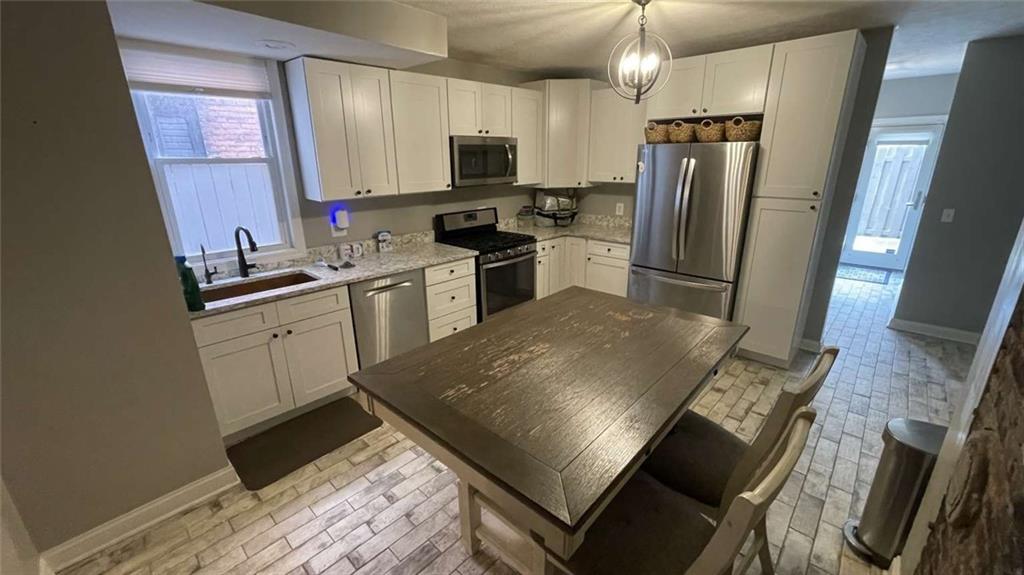 615 Tripoli Street Pittsburgh, PA 15212 - Photo 6 of 25 a kitchen with stainless steel appliances a stove refrigerator sink and microwave
