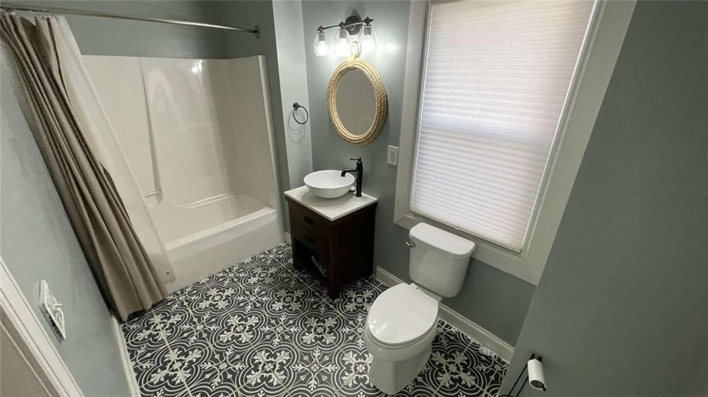 615 Tripoli Street Pittsburgh, PA 15212 - Photo 9 of 25 a bathroom with a sink a toilet and a mirror