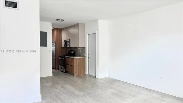 a kitchen with a refrigerator and a stove