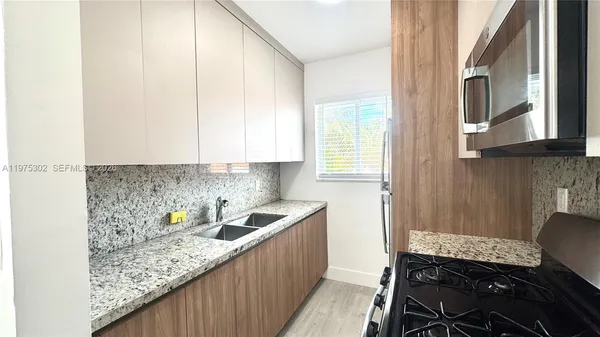 a kitchen with a sink and cabinets