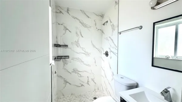 a bathroom with a toilet and shower