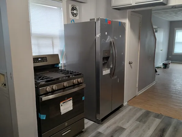 a kitchen with a stove and a refrigerator