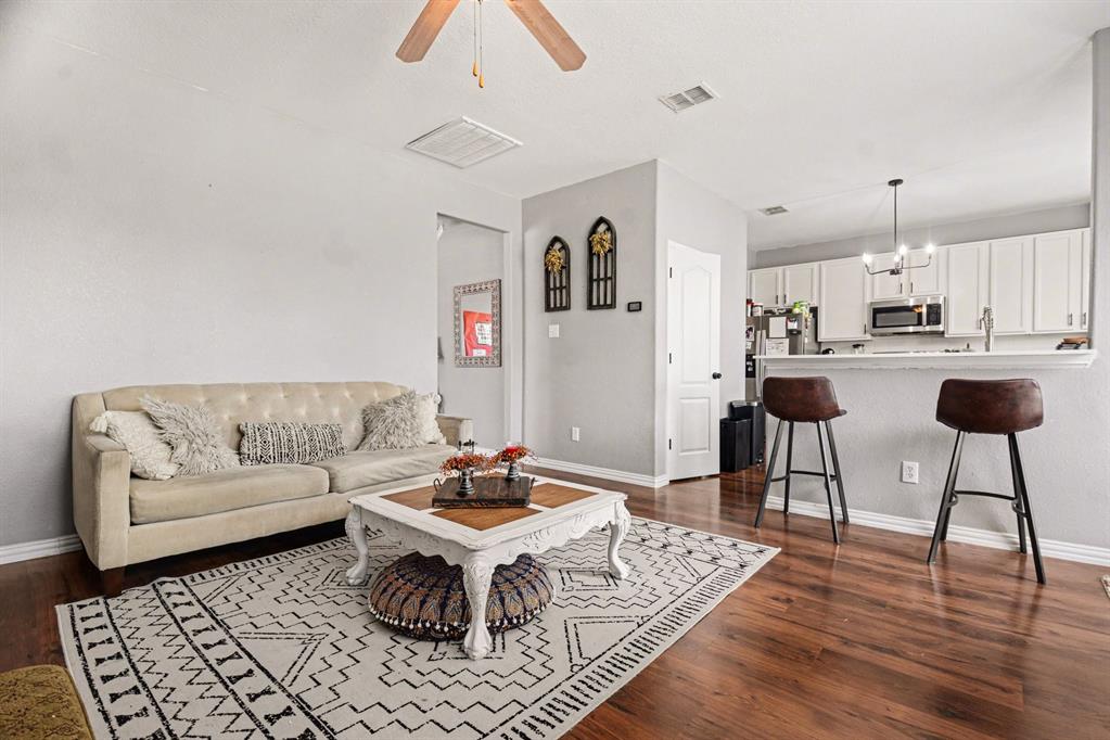10005 Turrey Rowlett, TX 75089 - Photo 13 of 32 Living room featuring a ceiling fan and dark wood-style floors