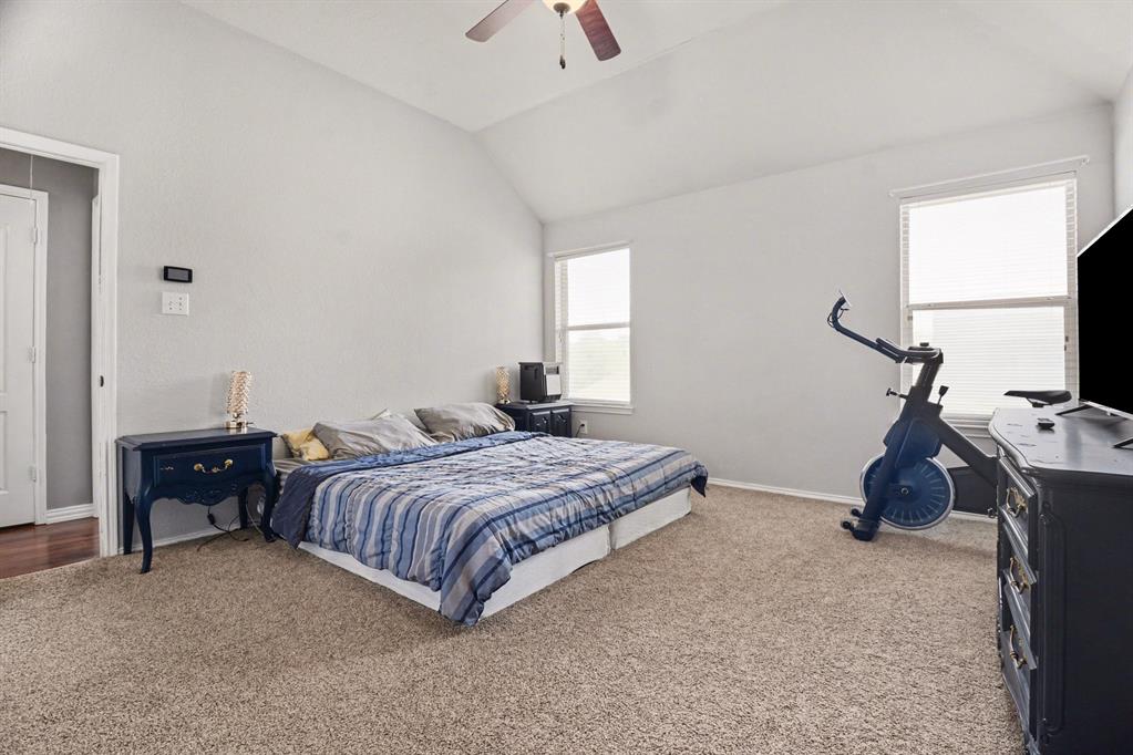 10005 Turrey Rowlett, TX 75089 - Photo 15 of 32 Bedroom featuring lofted ceiling, light carpet, and ceiling fan