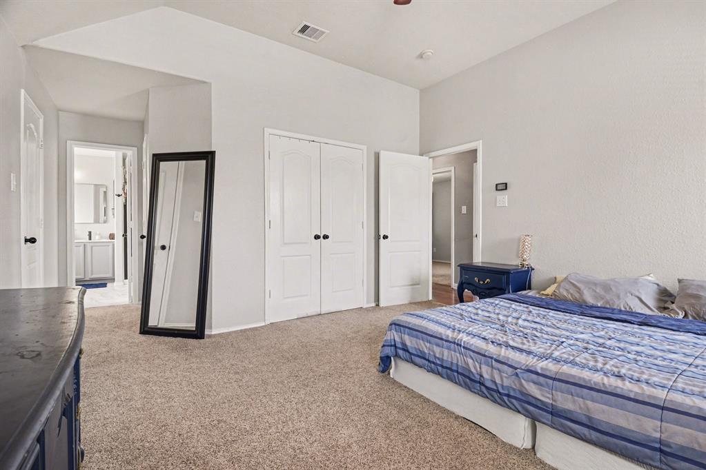 10005 Turrey Rowlett, TX 75089 - Photo 17 of 32 Bedroom featuring light colored carpet, a closet, and a ceiling fan