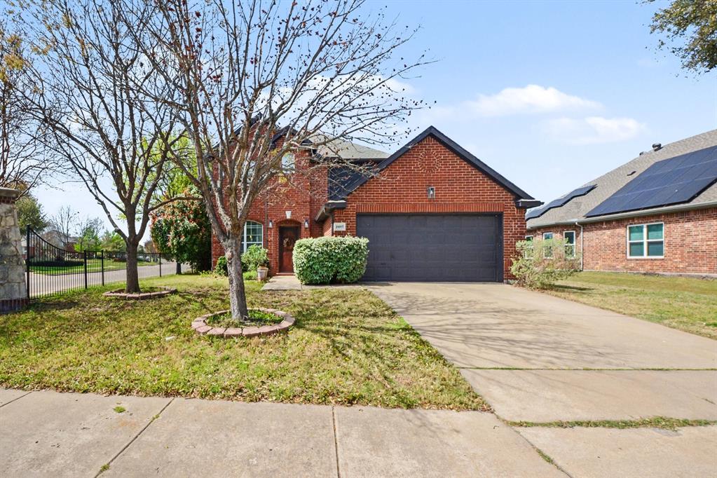 10005 Turrey Rowlett, TX 75089 - Photo 2 of 32 Traditional-style home with brick siding, concrete driveway, and an attached garage