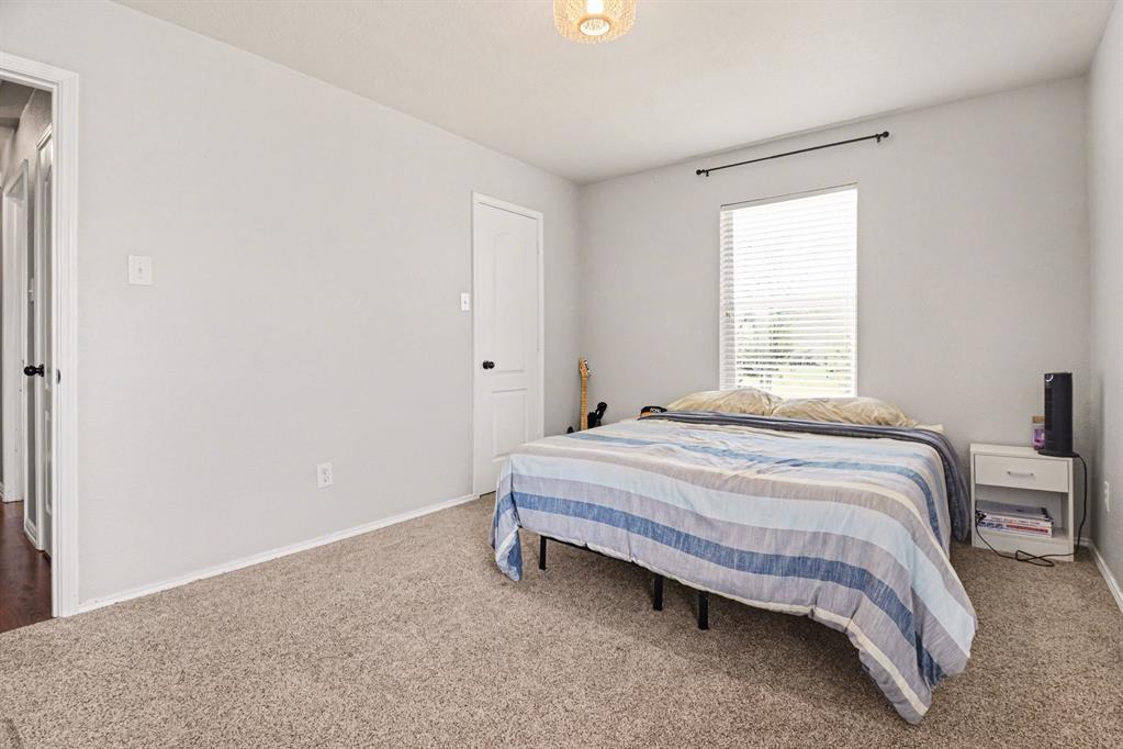 10005 Turrey Rowlett, TX 75089 - Photo 23 of 32 Bedroom featuring light colored carpet and baseboards