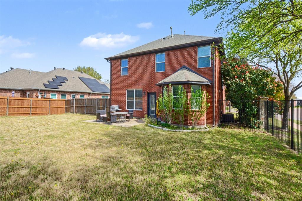 10005 Turrey Rowlett, TX 75089 - Photo 30 of 32 Back of house with a patio, a fenced backyard, and brick siding