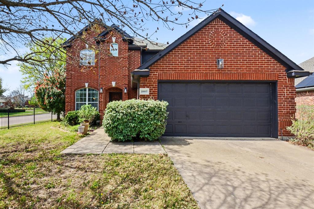 10005 Turrey Rowlett, TX 75089 - Photo 3 of 32 Traditional home with concrete driveway, a garage, and brick siding