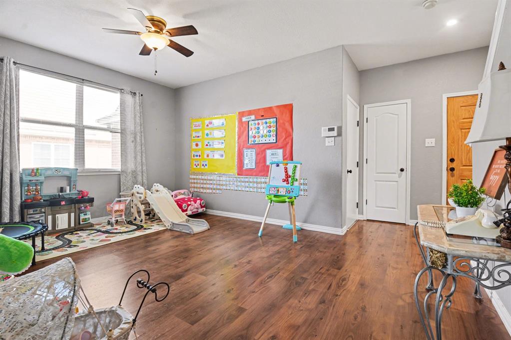 10005 Turrey Rowlett, TX 75089 - Photo 4 of 32 Rec room with a ceiling fan and dark wood-type flooring