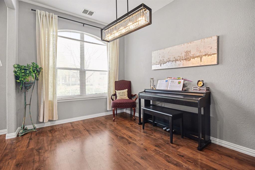 10005 Turrey Rowlett, TX 75089 - Photo 5 of 32 Living area featuring dark wood-style flooring and a textured wall