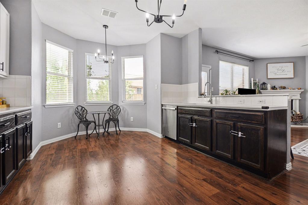 10005 Turrey Rowlett, TX 75089 - Photo 9 of 32 Kitchen with a peninsula, tasteful backsplash, dark wood-style flooring, and suspended lighting