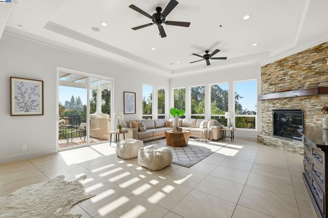a living room with furniture a large window and a fireplace