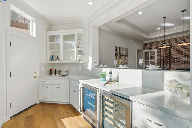 a spacious bedroom with a bed a couch and a chandelier