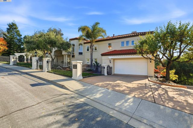 a view of a house with a yard and a garage