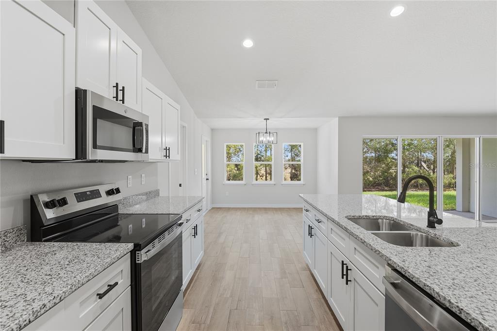 13161 Southwest 60th Avenue Ocala, FL 34473 - Photo 16 of 36 a kitchen that has a sink and a stove