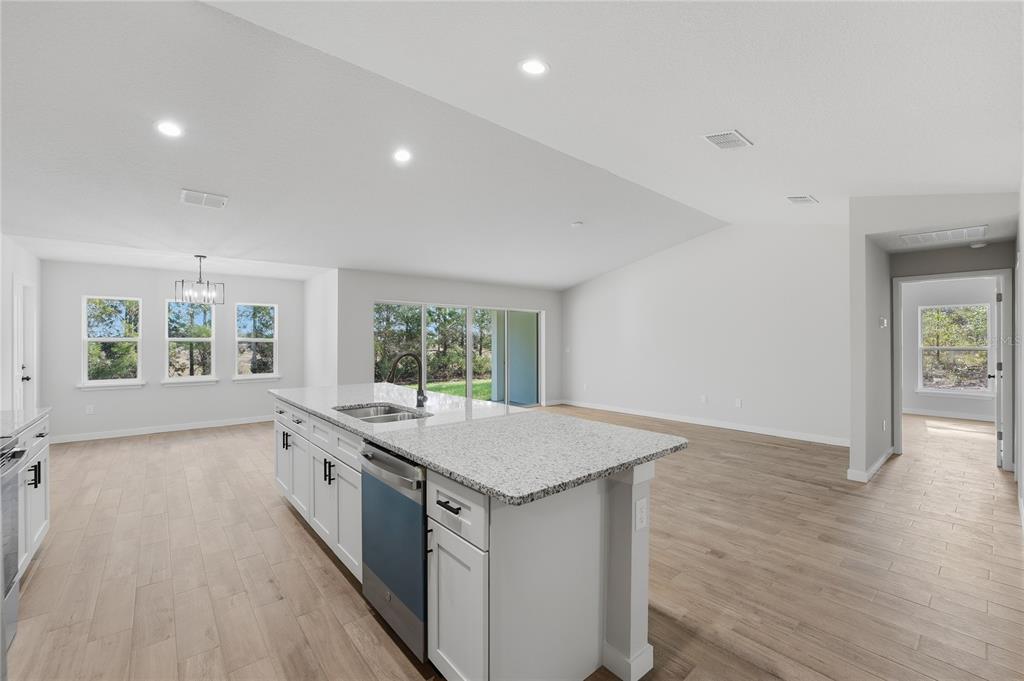 13161 Southwest 60th Avenue Ocala, FL 34473 - Photo 17 of 36 an open kitchen with a sink and large window