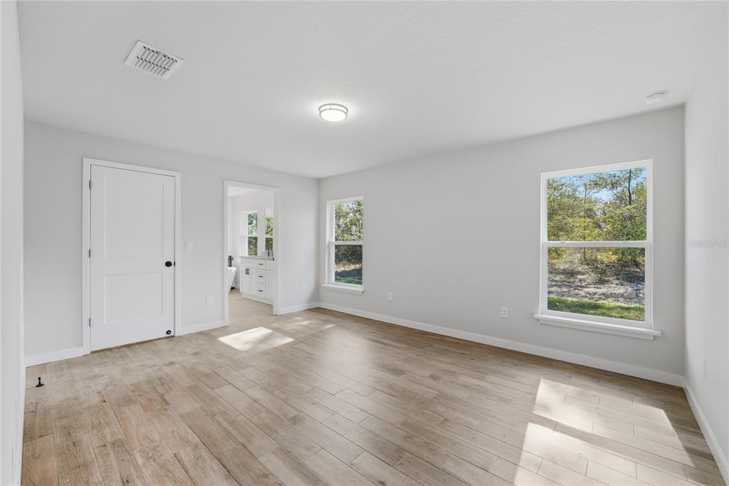 13161 Southwest 60th Avenue Ocala, FL 34473 - Photo 18 of 36 an empty room with wooden floor and windows