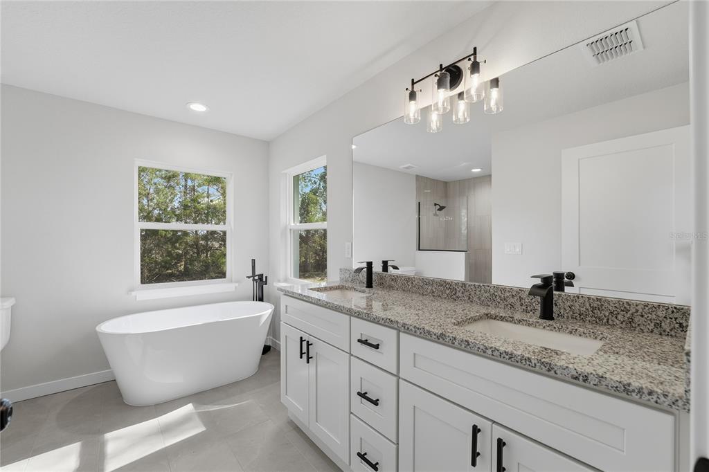13161 Southwest 60th Avenue Ocala, FL 34473 - Photo 20 of 36 a spacious bathroom with a large tub sink and mirror