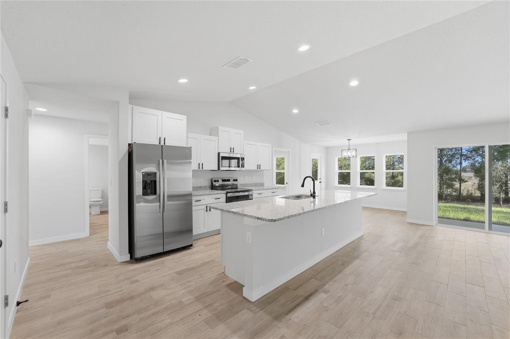 13161 Southwest 60th Avenue Ocala, FL 34473 - Photo 8 of 36 a view of kitchen with refrigerator stove and cabinets