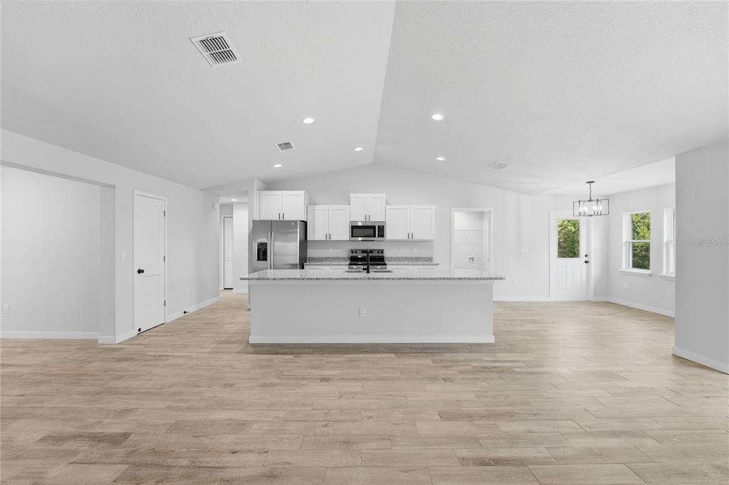 13161 Southwest 60th Avenue Ocala, FL 34473 - Photo 9 of 36 a view of kitchen with kitchen island white cabinets and stainless steel appliances