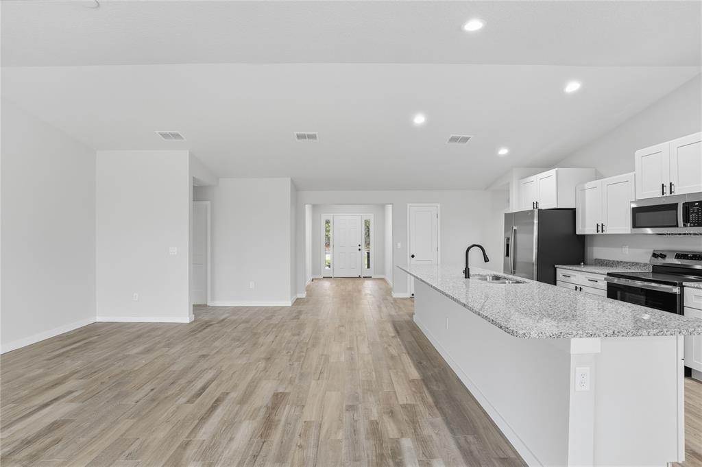 13161 Southwest 60th Avenue Ocala, FL 34473 - Photo 10 of 36 a large kitchen with a large counter top appliances and cabinets