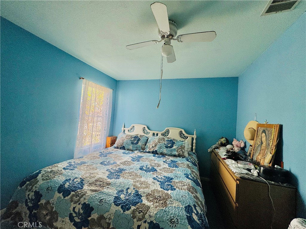 812 East 8th Street Long Beach, CA 90813 - Photo 11 of 40 a bedroom with a bed and ceiling fan