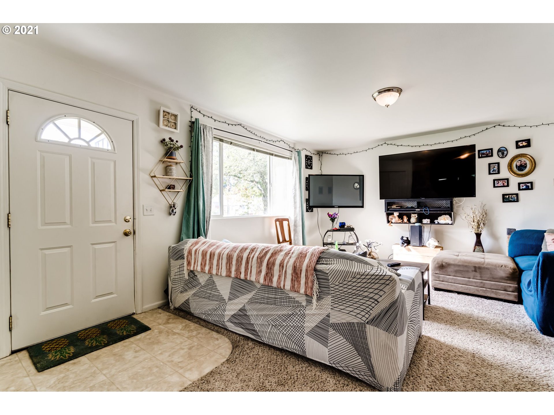 814 L Street Springfield, OR 97477 - Photo 6 of 23 a living room with furniture a flat screen tv and kitchen view