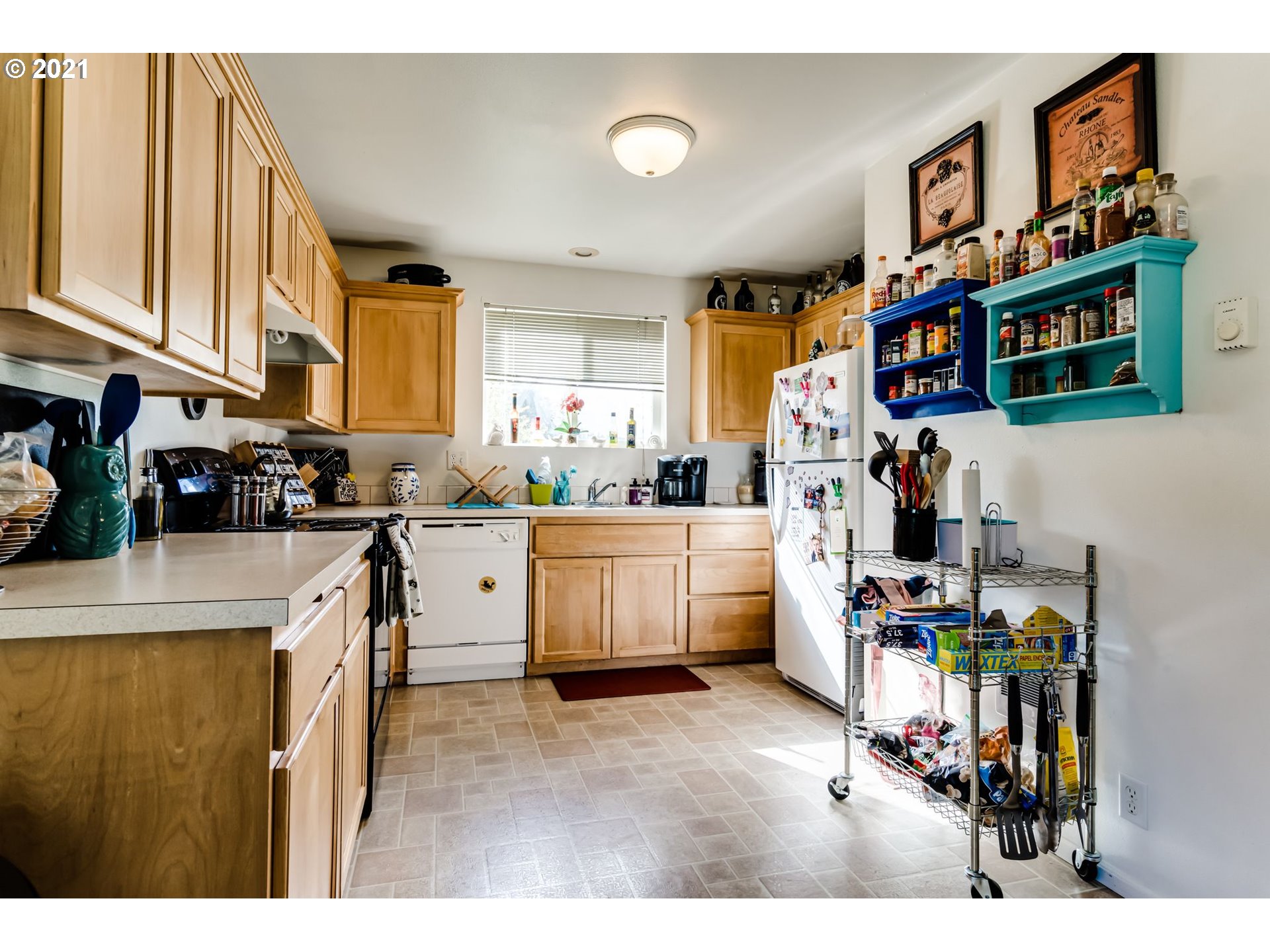 814 L Street Springfield, OR 97477 - Photo 10 of 23 a kitchen that has a lot of cabinets a sink and a stove