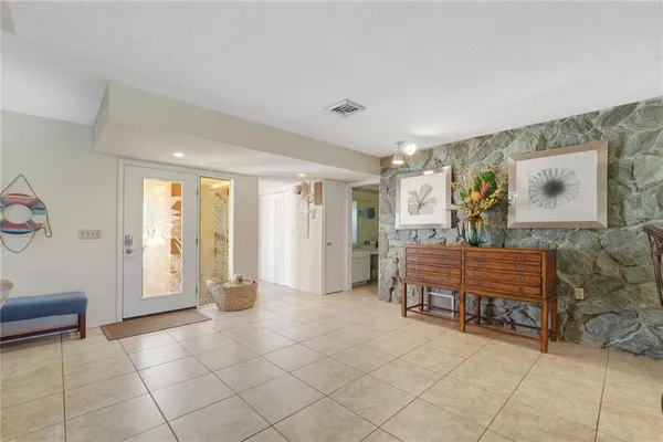a view of a dining room and livingroom furniture wooden floor a chandelier