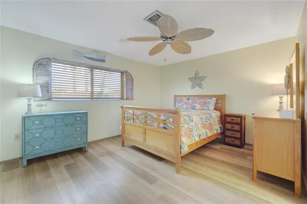 a bedroom with a bed and a chandelier